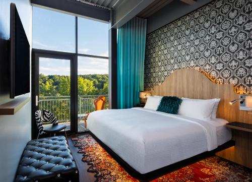 a bedroom with a large bed and a large window at Hotel Nyack, a JdV by Hyatt Hotel in Nyack