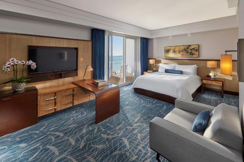 a hotel room with a bed and a television at Mandarin Oriental Miami in Miami