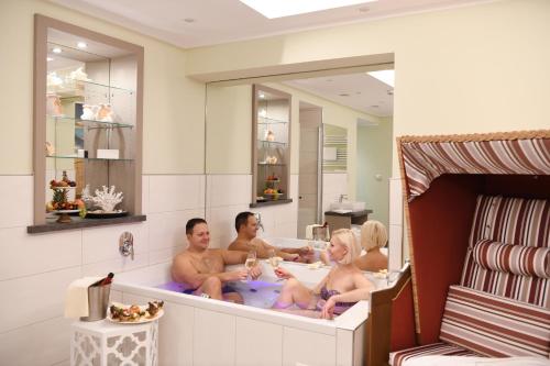 a group of people sitting in a bath tub at Moselstern Parkhotel Krähennest in Löf