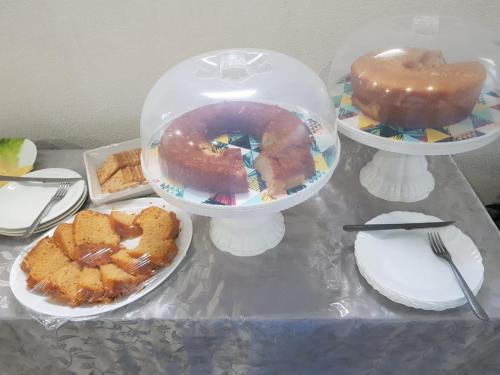 a table topped with plates of food and desserts at PEDRA BONITA PRECIOSO HOTEL ltda in Itaboraí