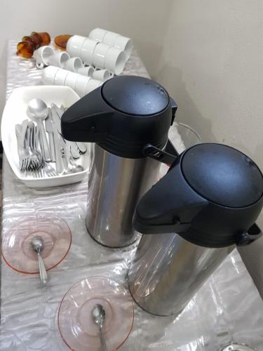 two utensils sitting on top of a table at PEDRA BONITA PRECIOSO HOTEL ltda in Itaboraí