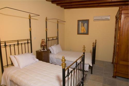 a bedroom with two beds in a room at Porfyrios Country House in Chirokitia