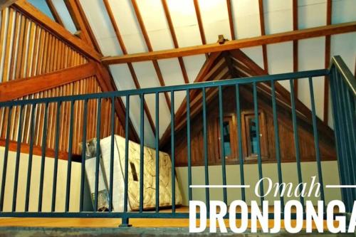 a bed in a cage in a room at Omah Dronjongan Homestay Yogyakarta in Yogyakarta