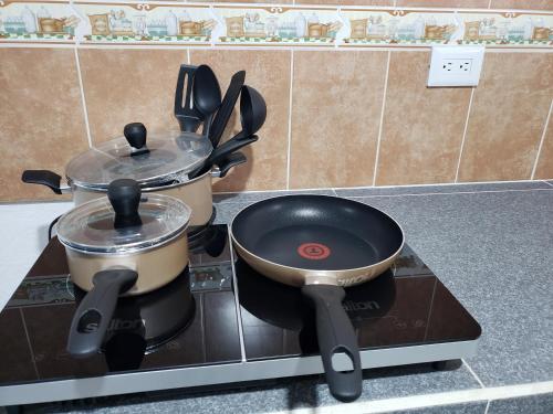 two pots and pans sitting on top of a stove at Casa Zac Nicte Mx-Estudio SISAL in Cancún