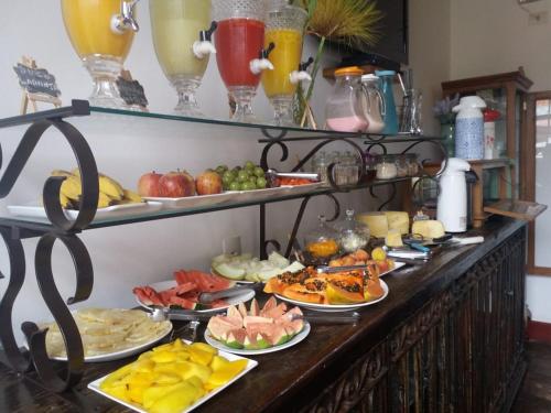 a buffet with many plates of food on a table at Pousada Araujo Bazilio in Tiradentes