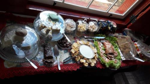 a table topped with food and plates of food at Pousada Araujo Bazilio in Tiradentes