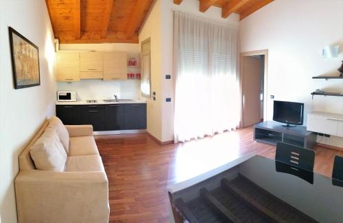 a living room with a couch and a kitchen at Hotel Residence Zodiaco in Modena