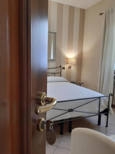 a room with two beds in a room with a door at Sweet House Only Rooms in Peschiera del Garda
