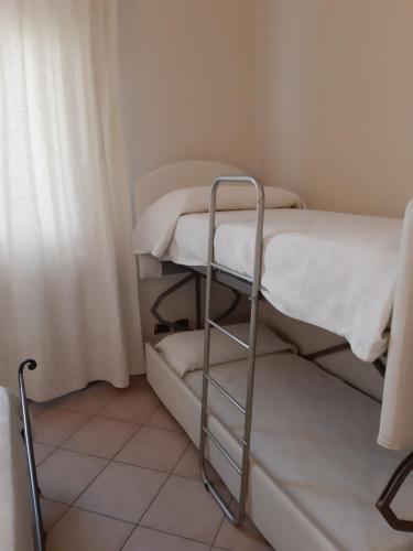a small room with two bunk beds in it at Sweet House Only Rooms in Peschiera del Garda