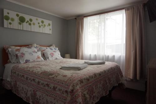 1 dormitorio con cama y ventana en Casa Pali en Puerto Montt