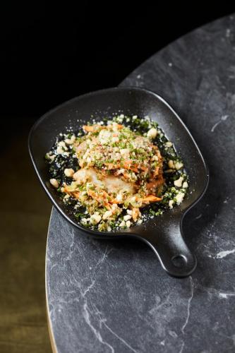 a pan filled with food on top of a table at Nonam Boutique Hotel Gent in Ghent