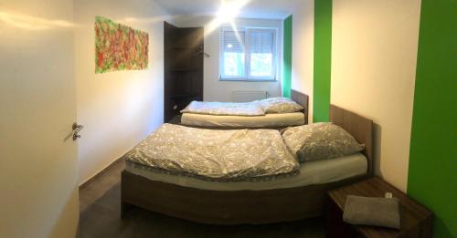 two beds in a room with green and white walls at KS GbR Wohnungen in Mechernich