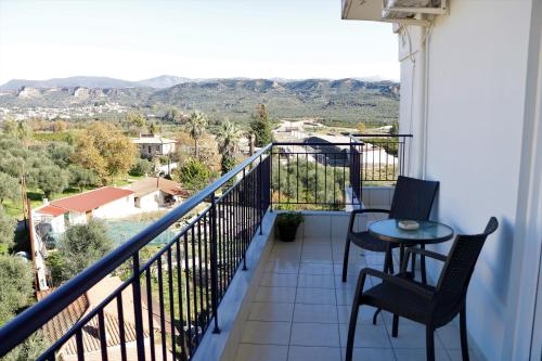 a balcony with a table and chairs and a view at Laconian Collection "Lykourgou 10" in Sparti
