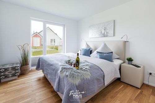 a bedroom with a bed with a bottle of wine on it at Frische Brise in Olpenitz