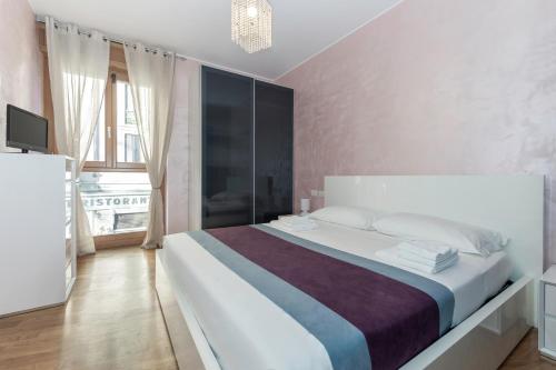 a bedroom with a large bed with a large window at Casa da Suite Fantasia in Milan