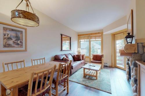 a living room with a table and a couch at Tucker Mountain Lodge 321 in Copper Mountain