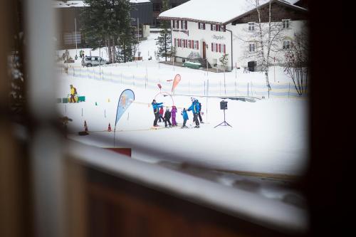 a group of people on skis in the snow at Fürmesli Appartements in Lech am Arlberg