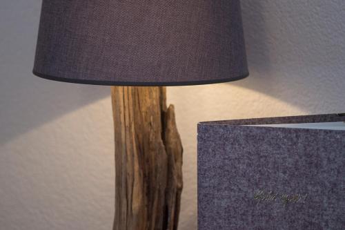 a wooden lamp with a shade on a table at Fürmesli Appartements in Lech am Arlberg