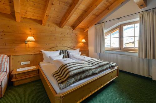a bedroom with a bed in a wooden room at Fürmesli Appartements in Lech am Arlberg