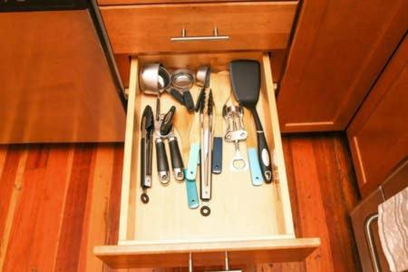 a group of kitchen utensils in a drawer at Stylish Apartment in Malden. 20 min from Boston in Malden