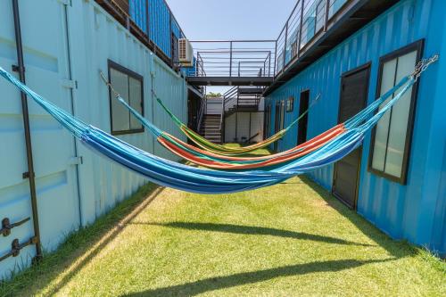 a couple of hammocks hanging between two buildings at Eco Gostoso in São Miguel do Gostoso