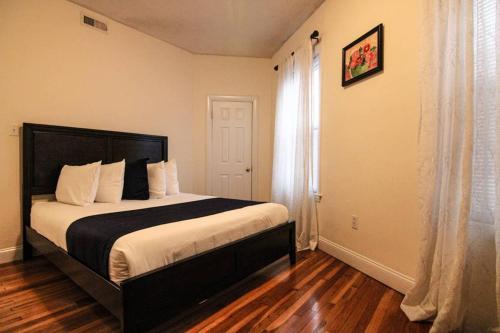 a bedroom with a large bed and a window at Stylish 1BR in Malden #3 in Malden