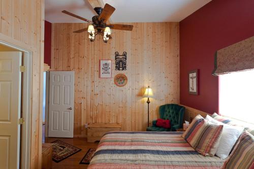 a bedroom with a bed and a ceiling fan at Sea Parrot Inn in Seldovia