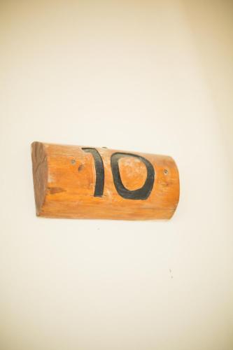 a wooden sign with the number on a wall at Paamul Hotel in Paamul