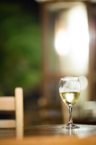 a glass of white wine sitting on a table at Paamul Hotel in Paamul