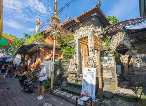 a man standing in front of a building in a market at Sania's House in Ubud