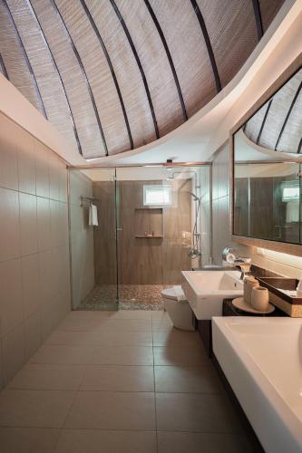 a bathroom with a shower and a toilet and a sink at Weekends El Nido Beach Resort in El Nido