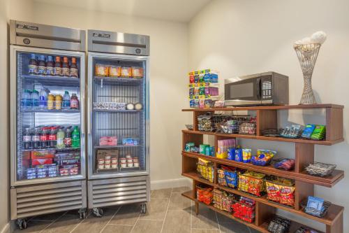 a room with a refrigerator filled with lots of food at Holiday Inn Express & Suites Panama City Beach - Beachfront, an IHG Hotel in Panama City Beach