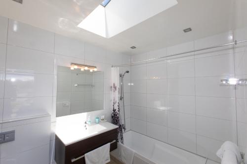 a white bathroom with a sink and a shower at Three Rivers Lodge in Lake Tekapo