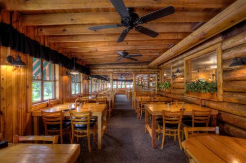 a dining room with wooden tables and chairs at Powder House Lodge in Keystone