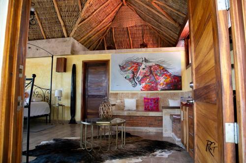 a room with a table and a painting on the wall at Casa Miura Hotel Boutique in Ajijic