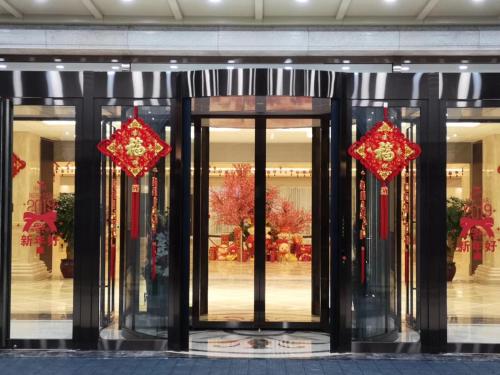 a store front with glass doors with red and gold decorations at SSAW Boutique Hotel Lishui Jiarui in Lishui
