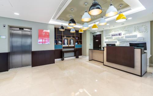 a lobby of a store with a waiting room at Premier Inn Doha Airport in Doha