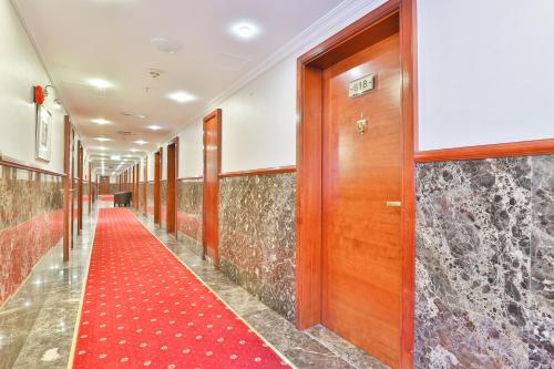 a corridor with a red carpet in a building at Sun And Sands Downtown in Dubai