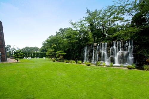 a waterfall in a park with green grass at Okayama International Hotel in Okayama