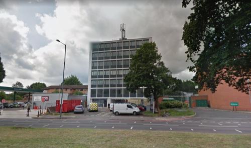 a large building with a car parked in a parking lot at Birmingham NECAirport Interchange shortstay homebase in Birmingham