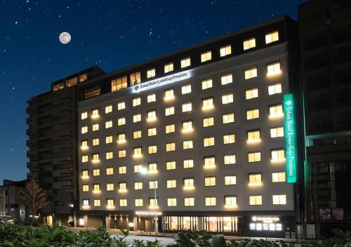 a large building with a moon in the sky at Urban Hotel Kyoto Gojo Premium in Kyoto