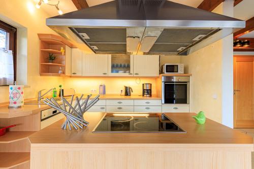 a kitchen with white cabinets and a stove top oven at Ferienwohnung Isabella am Möhnesee in Möhnesee