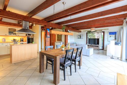 a kitchen and dining room with a wooden table and chairs at Ferienwohnung Isabella am Möhnesee in Möhnesee