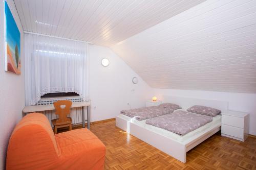 a bedroom with a bed and a desk and a chair at Apartment Harmony Bled in Bled