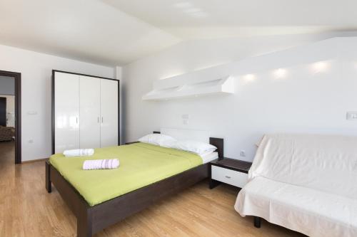a bedroom with two beds and a mirror at Apartments Darko near the sea in Baška