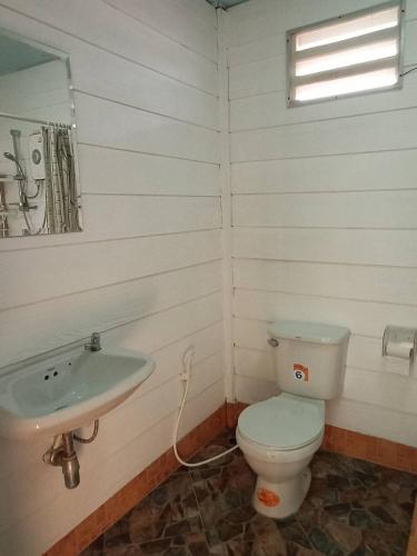 a bathroom with a toilet and a sink at PRAN Sea & Sun1 in Ban Pak Nam Pran