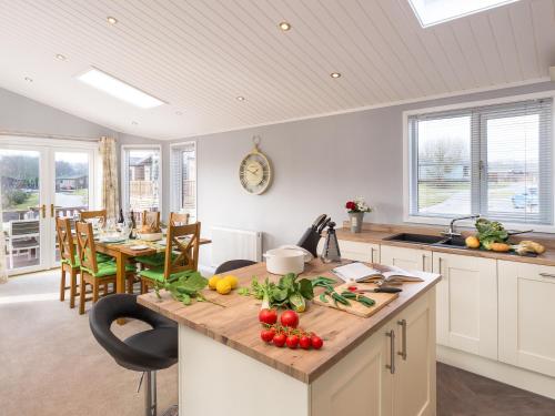 a kitchen with a counter with fruits and vegetables on it at Waternook Lodge in Carnforth