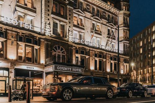 a car parked on a street in front of a building at County Hotel & County Aparthotel Newcastle in Newcastle upon Tyne