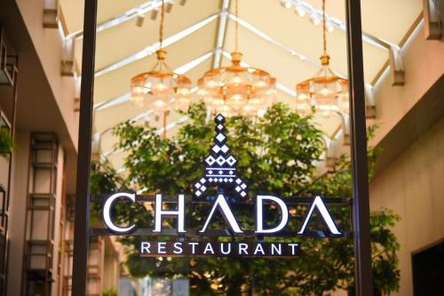 a chanda restaurant sign in the window of a store at Divalux Resort & Spa Bangkok, Suvarnabhumi Airport-Free Shuttle in Lat Krabang