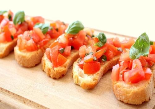 a group of sandwiches with tomatoes on a cutting board at Club del Sole Stork Family Collection in Giulianova